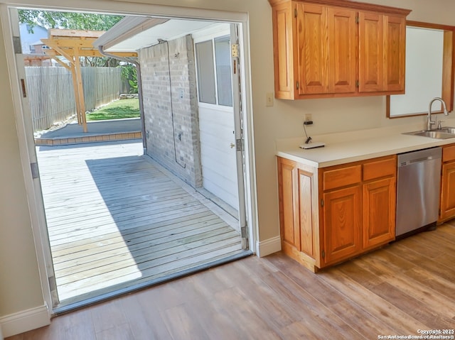 6718 Congressional Blvd, San Antonio, TX 78244 - kitchen featuring dishwasher, a sink, light wood finished floors, and light countertops