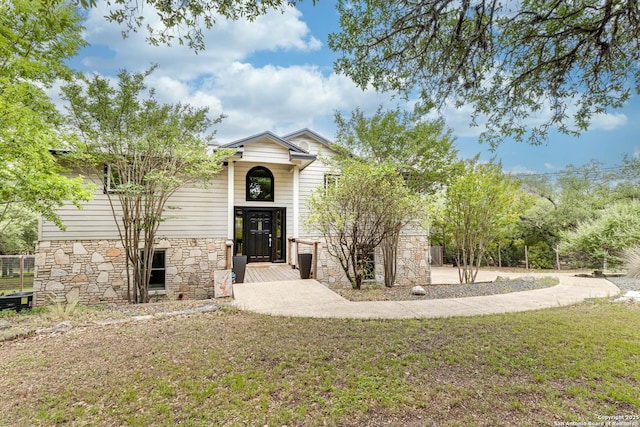 9811 Rebel Queen, San Antonio, TX 78255 - view of front of house featuring stone siding and a front lawn