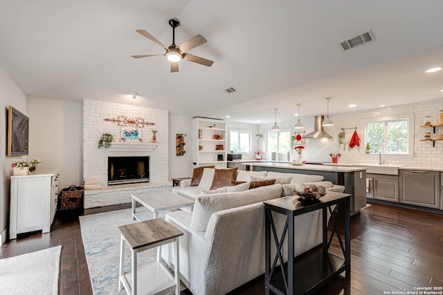 9811 Rebel Queen, San Antonio, TX 78255 - living room featuring ceiling fan, healthy amount of natural light, dark wood-style floors, a stone fireplace, and lofted ceiling