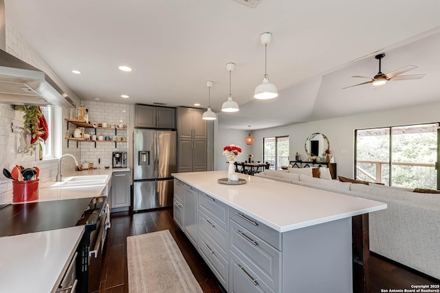 9811 Rebel Queen, San Antonio, TX 78255 - kitchen with stainless steel appliances, gray cabinets, open floor plan, a sink, and dark wood-style floors