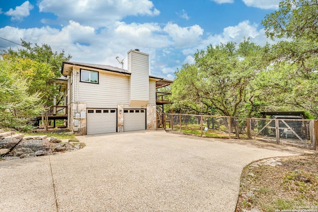 9811 Rebel Queen, San Antonio, TX 78255 - view of property exterior with stone siding, driveway, fence, and a chimney