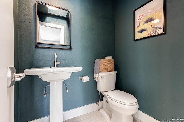 9811 Rebel Queen, San Antonio, TX 78255 - bathroom featuring baseboards, toilet, and wood finished floors
