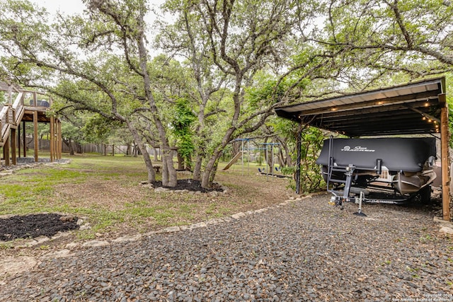 9811 Rebel Queen, San Antonio, TX 78255 - view of yard featuring a detached carport, a playground, and fence