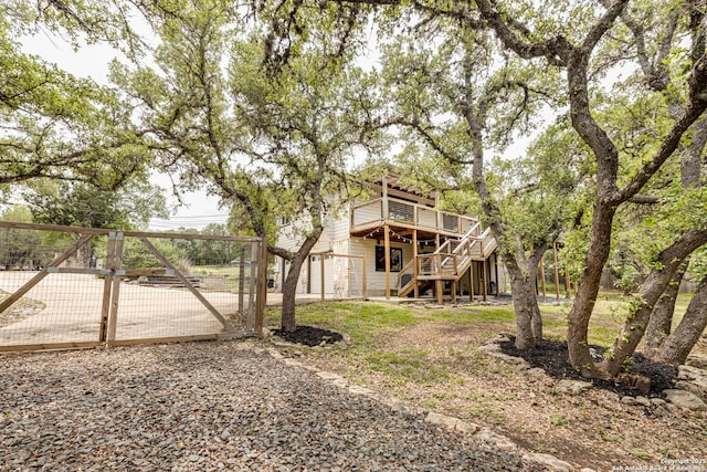 9811 Rebel Queen, San Antonio, TX 78255 - back of property with a gate, stairway, a wooden deck, and fence