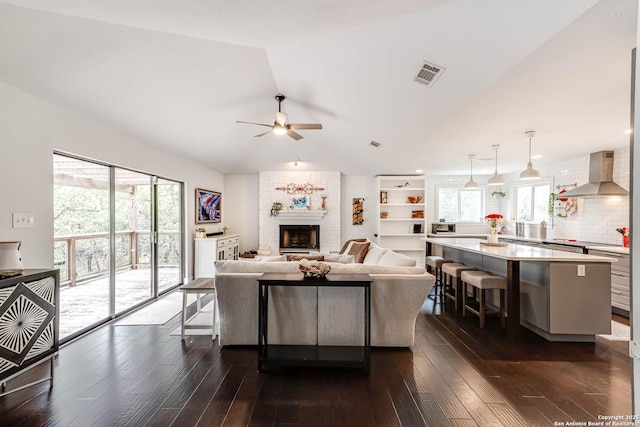 9811 Rebel Queen, San Antonio, TX 78255 - living room featuring ceiling fan, lofted ceiling, dark wood-style flooring, and a large fireplace