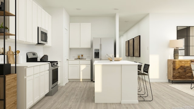 31951 Ambrose St, Bulverde, TX 78163 - kitchen featuring stainless steel appliances, light wood finished floors, an island with sink, backsplash, and white cabinets