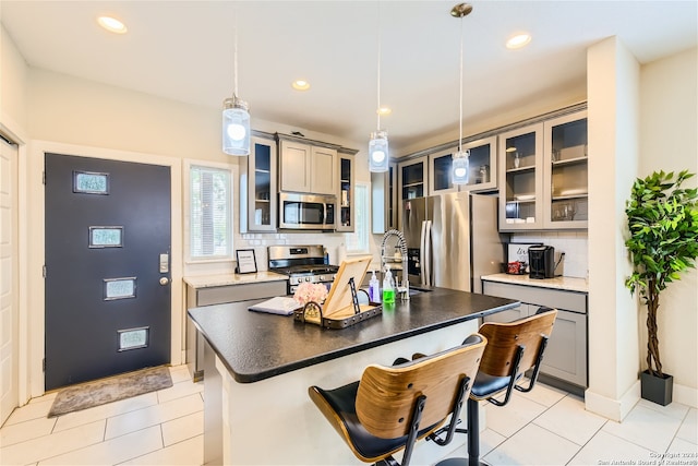 1130 Wyoming St Unit B, San Antonio, TX 78203 - kitchen featuring appliances with stainless steel finishes, a sink, decorative backsplash, gray cabinetry, and light tile patterned floors