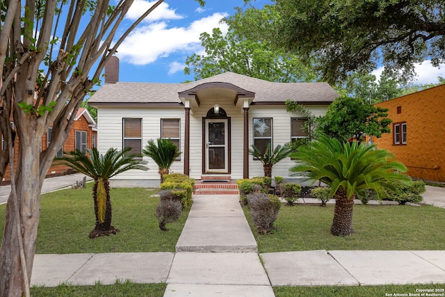 1717 W Summit Ave, San Antonio, TX 78201 - view of front of property with a front lawn and a shingled roof