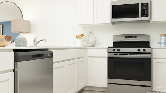 kitchen featuring stainless steel appliances, light countertops, white cabinets, and a sink