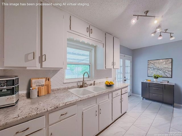 155 Eland, San Antonio, TX 78213 - kitchen with a sink, white cabinets, track lighting, a textured ceiling, and french doors