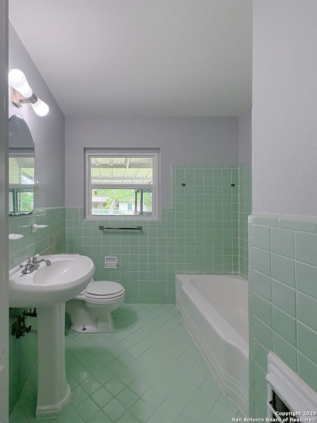 155 Eland, San Antonio, TX 78213 - full bath with tile walls, tile patterned flooring, toilet, a wainscoted wall, and healthy amount of natural light