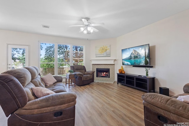 21503 Rio Comal, San Antonio, TX 78259 - living room with a ceiling fan, light wood-type flooring, and a brick fireplace