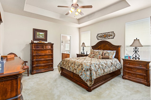 3136 San Miguel, New Braunfels, TX 78132 - bedroom with a raised ceiling, light colored carpet, ensuite bathroom, and a ceiling fan