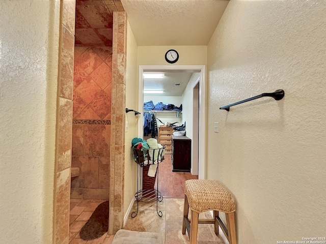 3389 Fm 888, Beeville, TX 78102 - full bathroom with a textured wall, a tile shower, and a textured ceiling