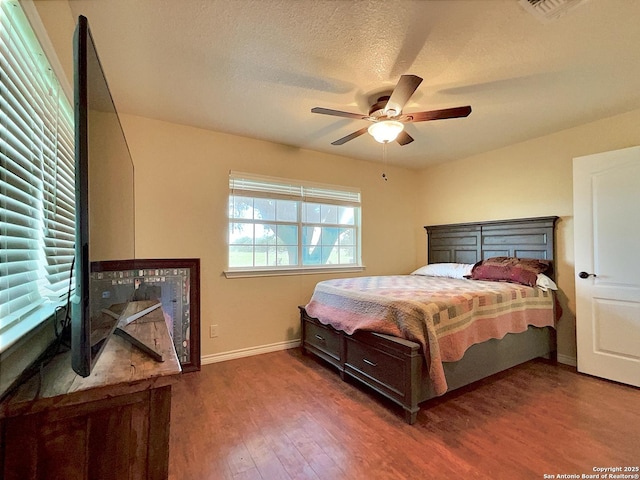 3389 Fm 888, Beeville, TX 78102 - bedroom featuring wood finished floors, baseboards, ceiling fan, and a textured ceiling