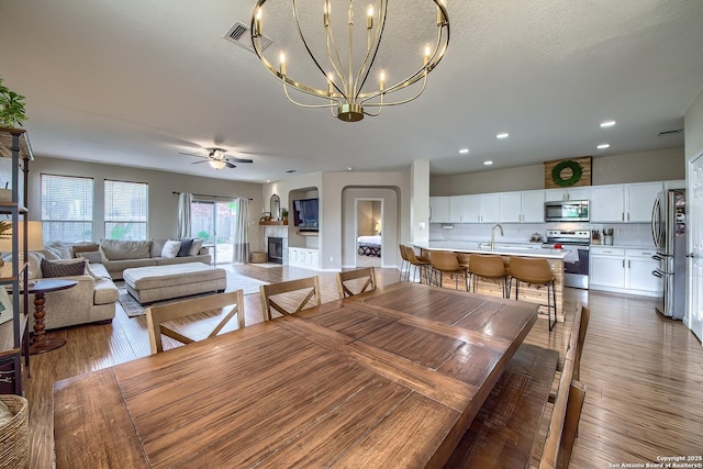 1227 Sun Spg, San Antonio, TX 78245 - dining room with ceiling fan, a chandelier, wood finished floors, and recessed lighting