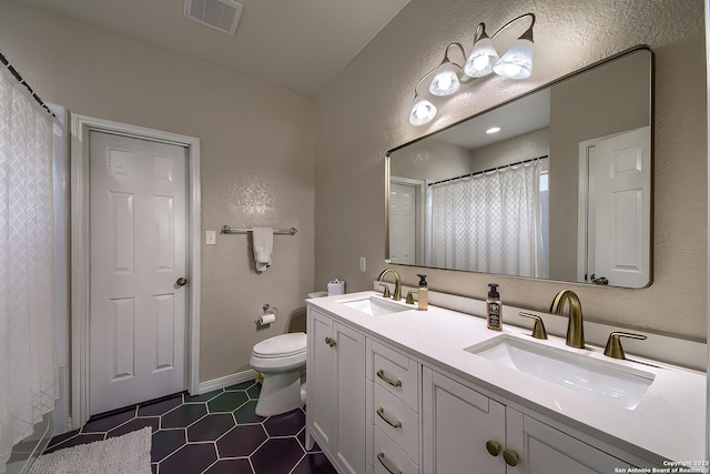 1227 Sun Spg, San Antonio, TX 78245 - full bathroom featuring toilet, tile patterned floors, double vanity, a shower with curtain, and a textured wall