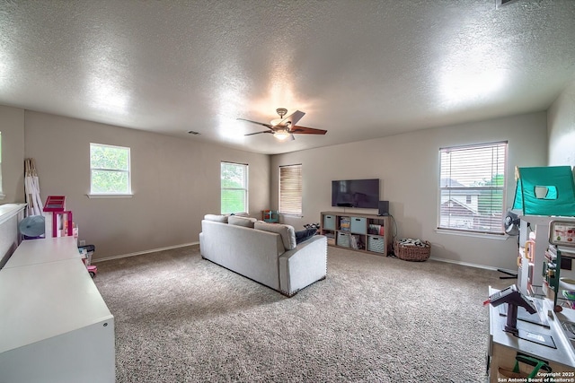 1227 Sun Spg, San Antonio, TX 78245 - living area featuring ceiling fan, carpet, baseboards, and a textured ceiling