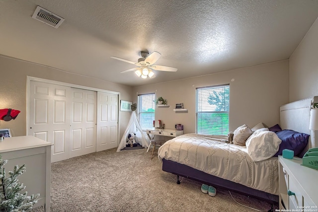 1227 Sun Spg, San Antonio, TX 78245 - bedroom with carpet flooring, a closet, a textured ceiling, and a ceiling fan
