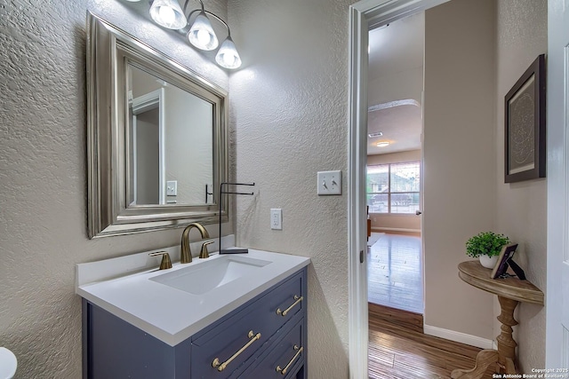 1227 Sun Spg, San Antonio, TX 78245 - bathroom with a textured wall, wood finished floors, and vanity