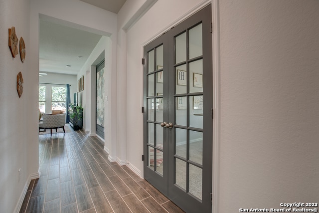 8907 Turkey Crk, Seguin, TX 78155 - corridor featuring french doors, baseboards, and dark wood finished floors