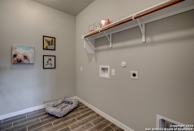 8907 Turkey Crk, Seguin, TX 78155 - washroom featuring electric dryer hookup, dark wood finished floors, hookup for a gas dryer, baseboards, and hookup for a washing machine