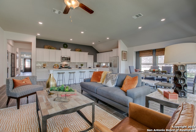 8907 Turkey Crk, Seguin, TX 78155 - living room with a ceiling fan, vaulted ceiling, and recessed lighting