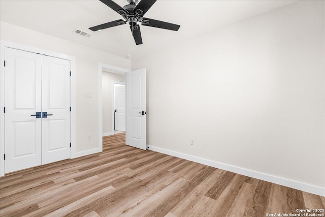unfurnished bedroom with light wood finished floors, baseboards, a closet, and ceiling fan