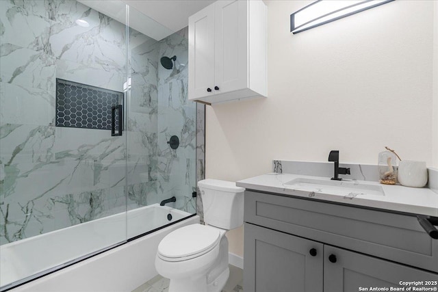 full bath featuring vanity, toilet, and bath / shower combo with glass door