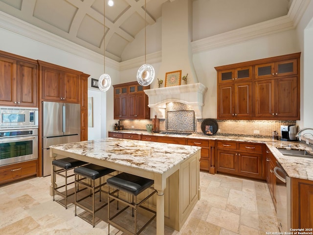 7 Naples Ct, San Antonio, TX 78257 - kitchen featuring stainless steel appliances, a sink, light stone countertops, a kitchen breakfast bar, and high vaulted ceiling