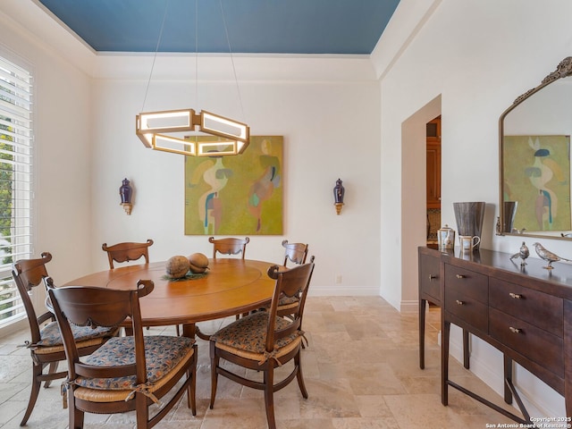 7 Naples Ct, San Antonio, TX 78257 - dining space with stone tile floors, plenty of natural light, baseboards, and ornamental molding