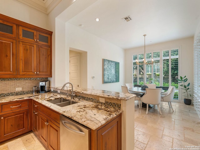 7 Naples Ct, San Antonio, TX 78257 - kitchen featuring dishwasher, a peninsula, a sink, brown cabinetry, and recessed lighting