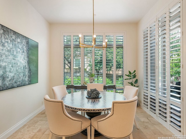 7 Naples Ct, San Antonio, TX 78257 - dining room with light stone finish floors, baseboards, and a chandelier