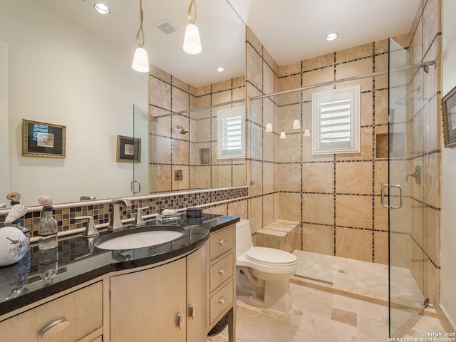 7 Naples Ct, San Antonio, TX 78257 - bathroom with decorative backsplash, vanity, a stall shower, toilet, and tile walls