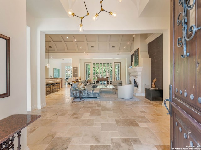7 Naples Ct, San Antonio, TX 78257 - foyer featuring stone tile flooring, coffered ceiling, baseboards, a chandelier, and beam ceiling