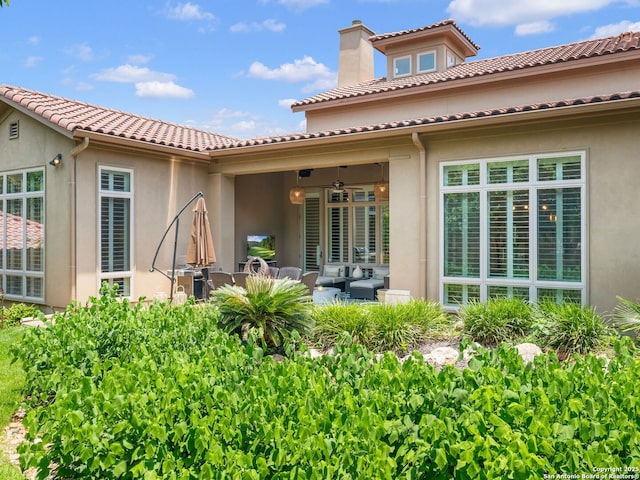 7 Naples Ct, San Antonio, TX 78257 - back of house with stucco siding, a chimney, outdoor lounge area, and a tile roof