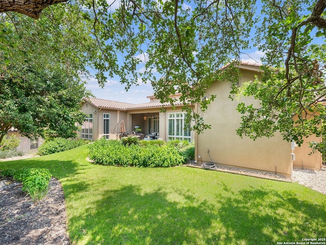 7 Naples Ct, San Antonio, TX 78257 - back of property with stucco siding, a yard, and a tile roof