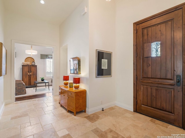 7 Naples Ct, San Antonio, TX 78257 - entrance foyer featuring stone tile flooring, baseboards, a towering ceiling, and recessed lighting