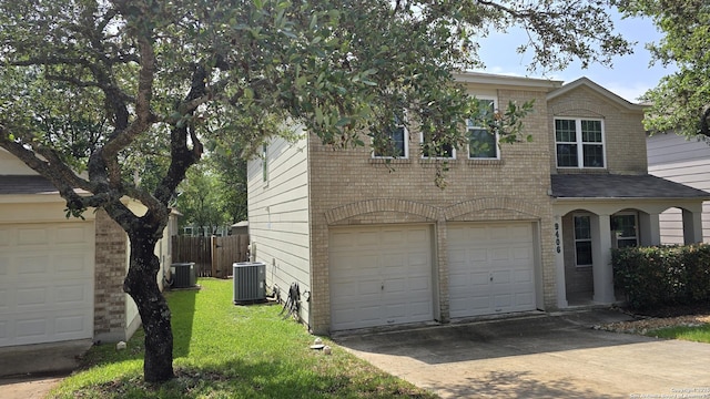 9406 Vallecito Pass, San Antonio, TX 78250 - view of front of property with cooling unit, brick siding, an attached garage, and driveway