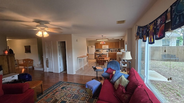 9406 Vallecito Pass, San Antonio, TX 78250 - living room featuring light wood finished floors, a ceiling fan, and baseboards