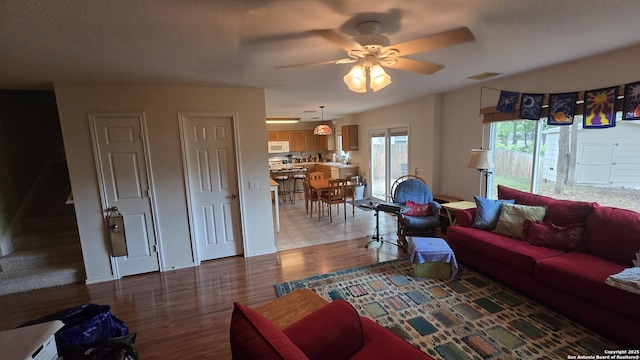 9406 Vallecito Pass, San Antonio, TX 78250 - living room with ceiling fan, light wood-style flooring, and baseboards