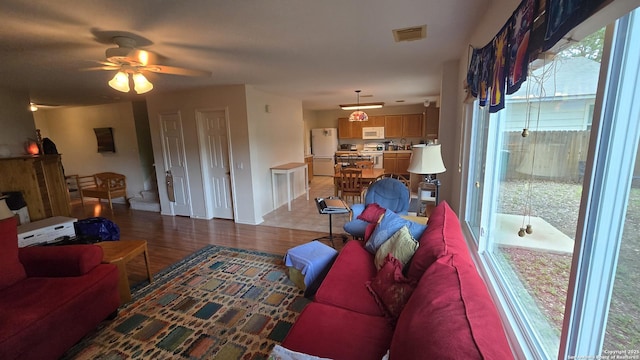 9406 Vallecito Pass, San Antonio, TX 78250 - living area with ceiling fan, wood finished floors, and baseboards