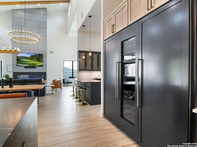 756 Annabelle Ave, Bulverde, TX 78163 - kitchen with built in fridge, a towering ceiling, light wood-style flooring, a chandelier, and open floor plan