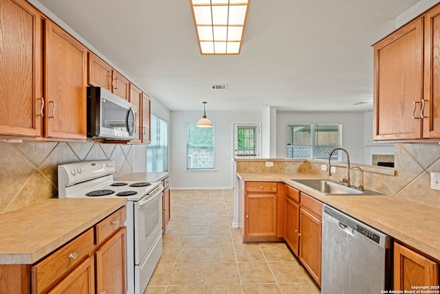 15603 Hastings Park, Selma, TX 78154 - kitchen featuring appliances with stainless steel finishes, a sink, light countertops, and tasteful backsplash
