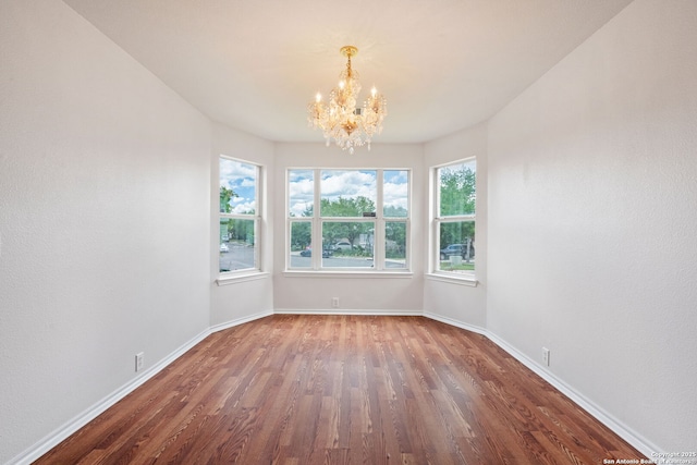 15603 Hastings Park, Selma, TX 78154 - unfurnished dining area with a chandelier, wood finished floors, and baseboards