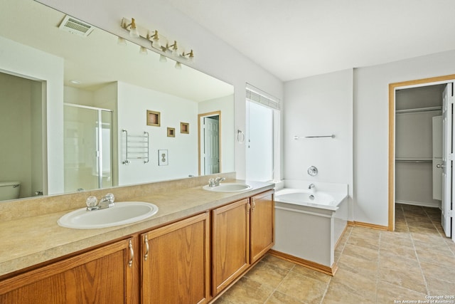 15603 Hastings Park, Selma, TX 78154 - bathroom featuring a stall shower, double vanity, a garden tub, and toilet