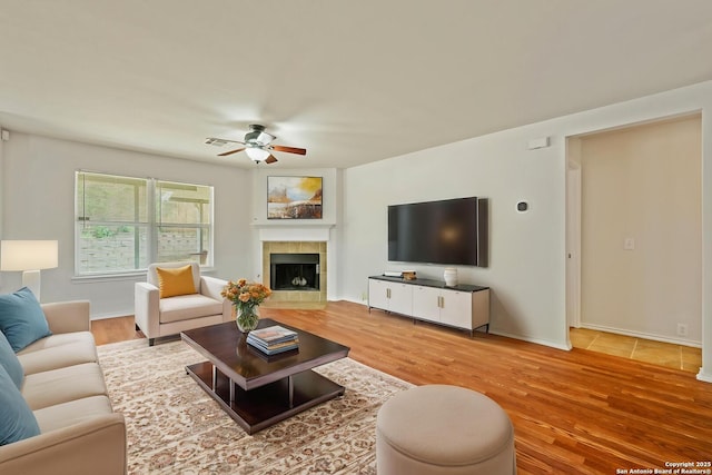 15603 Hastings Park, Selma, TX 78154 - living room featuring a ceiling fan, wood finished floors, a fireplace, and baseboards