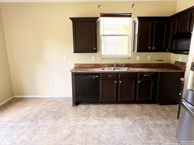 2211 Mission Verde, San Antonio, TX 78223 - kitchen with black appliances, a sink, baseboards, dark countertops, and dark brown cabinetry