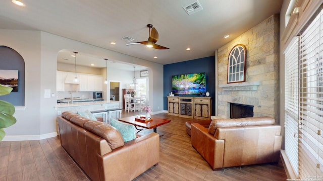 2542 Varrelmann, New Braunfels, TX 78132 - living area with wood finished floors, baseboards, a ceiling fan, a fireplace, and recessed lighting