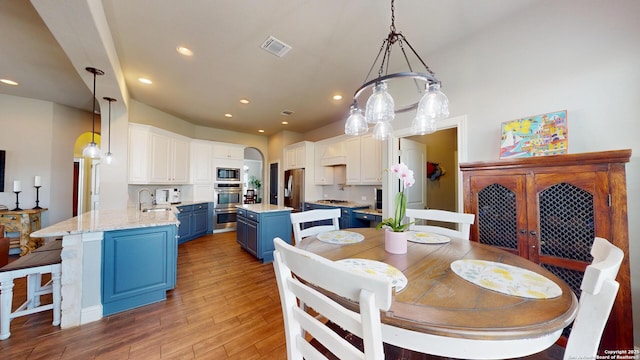 2542 Varrelmann, New Braunfels, TX 78132 - dining room with recessed lighting, light wood-type flooring, and arched walkways